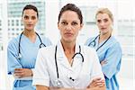 Portrait of confident female doctors with arms crossed at medical office