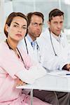 Portrait of confident doctors at desk in the medical office