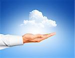 Cloud computing, close up of male hand holding cloud with copy space