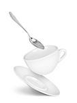 falling cup with saucer and spoon on isolated white background