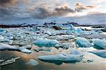 Sunset over Jokulsarlon, a glacial lagoon at the head of the Breidamerkurjokull Glacier on the edge of the Vatnajokull National Park, South Iceland, Iceland, Polar Regions