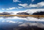 Mountains and glaciers on the edge of the Vatnajokull Ice Cap near Skaftafell National Park, reflecting in a nearby lake, South Iceland, Iceland, Polar Regions