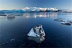 View of icebergs on Jokulsarlon, a glacial lagoon at the head of the Breidamerkurjokull Glacier, with some icebergs illuminated by the afternoon winter sun, on the edge of the Vatnajokull National Park, South Iceland, Iceland, Polar Regions