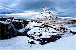 Kirkjufell (Church Mountain) covered in snow with a frozen river and waterfall in the foreground, near Grundarfjordur, Snaefellsnes Peninsula, Iceland, Polar Regions