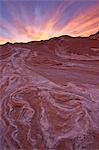 Brilliant orange clouds at sunset over red and white sandstone, White Pocket, Vermilion Cliffs National Monument, Arizona, United States of America, North America