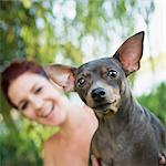 A woman with a small pet dog.