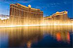 Bellagio and Caesars Palace reflections at dusk with fountains, The Strip, Las Vegas, Nevada, United States of America, North America