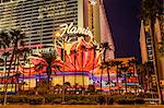 Neon lights, Las Vegas Strip at dusk with Flamingo Facade and palm trees, Las Vegas, Nevada, United States of America, North America