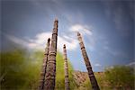 Naxi poles with wood carvings with moving clouds in a long exposure, Lijiang, Yunnan, China, Asia