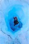 Woman standing in an Ice cave in the Fox Glacier, Westland Tai Poutini National Park, South Island, New Zealand, Pacific