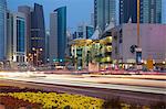 Contemporary architecture and traffic at dusk in the city centre, Doha, Qatar, Middle East