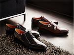 Two pairs of men's dress shoes on the floor, studio shot