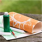 Art Supplies for Painting over Wax Drawings on Picnic Table Outdoors