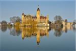 Schwerin Castle reflected in Schwerin Lake, Schwerin, Western Pomerania, Mecklenburg-Vorpommern, Germany