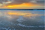 Sky at sunrise reflected on North Sea, beach and ocean at Helgoland, Schleswig-Holstein, Germany