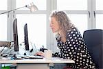 Mid adult woman working in office