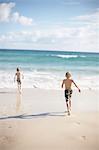 Boys running on beach