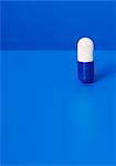 Close up of prescription pill on blue background