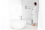 Blurred view of woman walking in modern bathroom