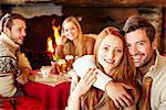 Couple hugging at restaurant with friends