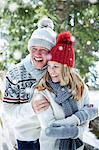 Couple hugging in the snow together