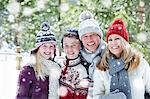 Family hugging in the snow