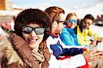 Woman sitting with friends in the snow