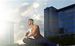 Man stretching before exercising on city street