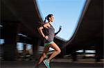 Woman running through city streets