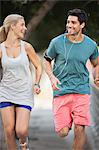 Couple running through city streets together