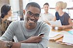 Businessman using cell phone at meeting in cafe