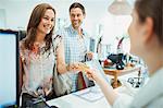 Couple paying with credit card in clothing store