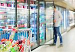 Defocussed view of man shopping in grocery store