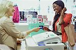 Woman paying with credit card in store