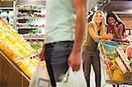 Women admiring man shopping in grocery store