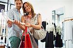 Couple admiring jewelry in clothing store