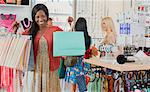 Woman holding shopping bags in clothing store