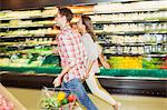 Blurred view of couple shopping together in grocery store