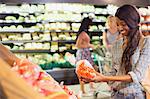 Woman shopping for produce in grocery store