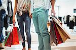 Couple carrying shopping bags in clothing store