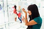 Woman trying out perfume in drugstore