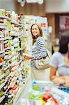 Smiling woman shopping in grocery store