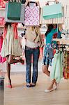 Women holding shopping bags in clothing store