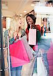 Women carrying shopping bags in store