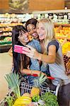 Women taking picture together in grocery store