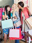 Women carrying shopping bags in clothing store