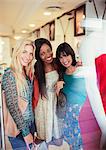 Women smiling together in clothing store