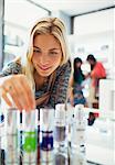 Woman examining skincare products in drugstore