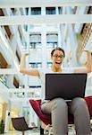 Businesswoman getting excited in office building