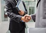 Businessmen shaking hands outdoors